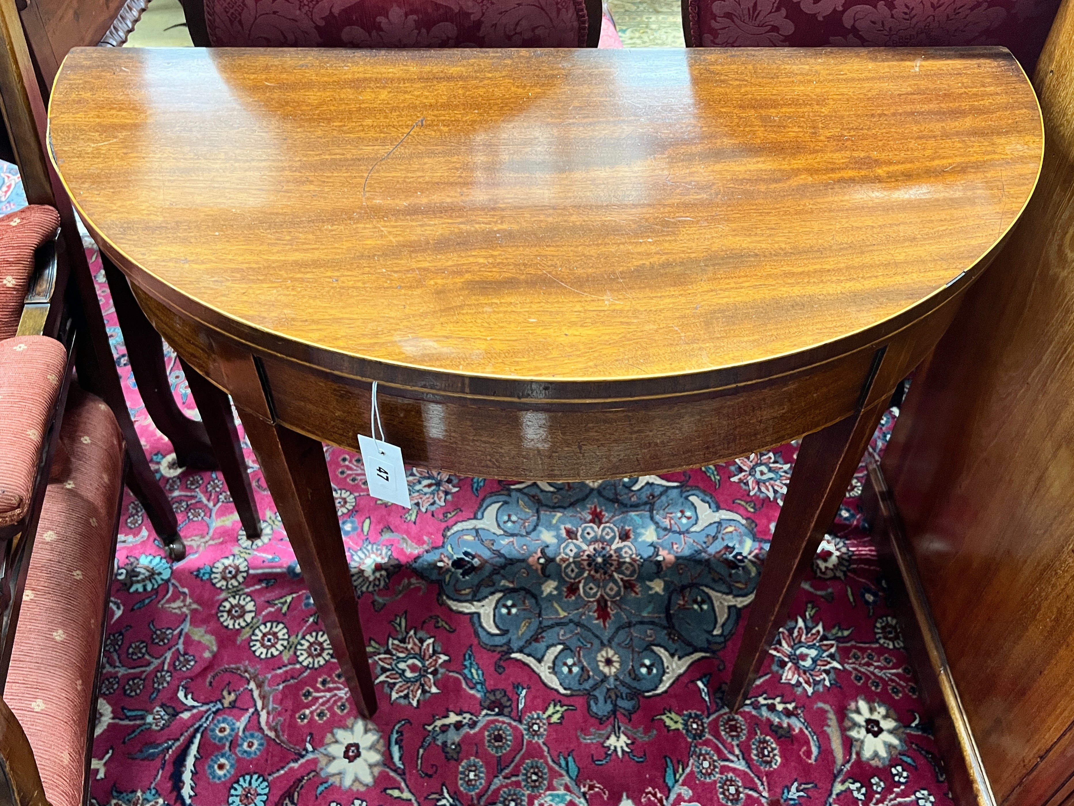 A George III mahogany D-shaped folding tea table, width 92cm, depth 46cm, height 73cm
